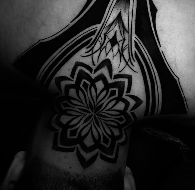Close up of a black and grey neotraditional tattoo on an arm, showing clean linework and soft shading